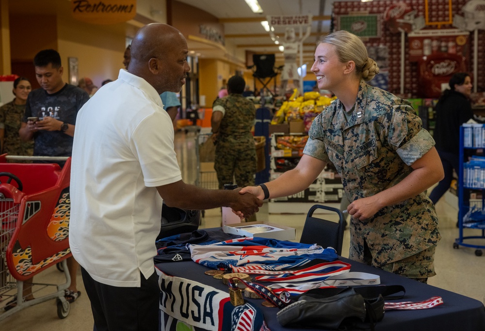 U.S. Marine Corps Capt. Riley Trejcek, an Olympic bobsledder, signs autographs at the commissary on Marine Corps Base Quantico