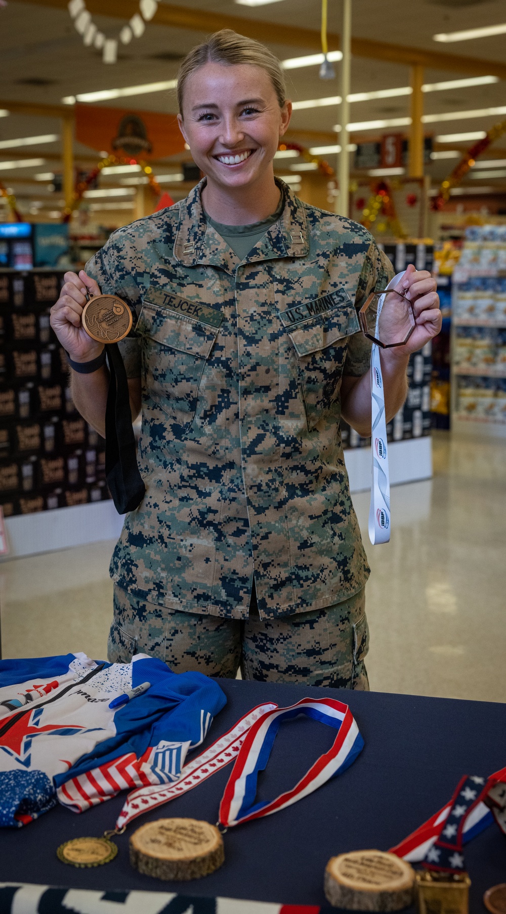 U.S. Marine Corps Capt. Riley Trejcek, an Olympic bobsledder, signs autographs at the commissary on Marine Corps Base Quantico