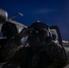 U.S. Army Door Gunner checks his night vision goggles