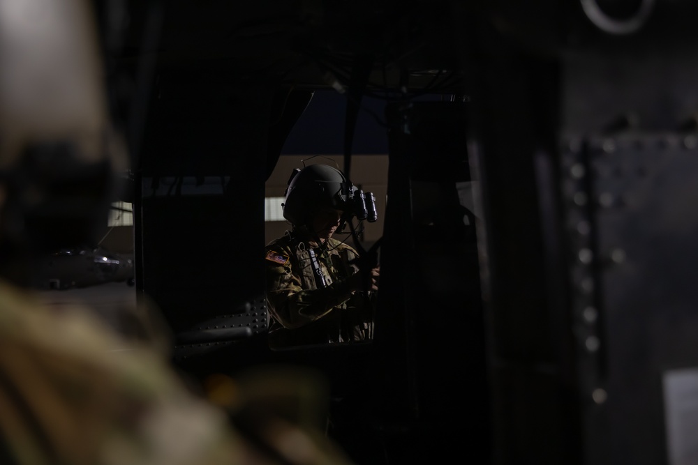 U.S. Army Door Gunner conducts pre-flight checks