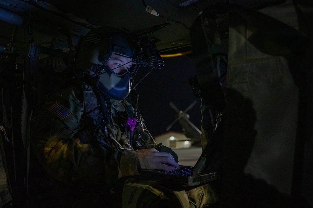 U.S. Army Crew Chief checks a onboard computer