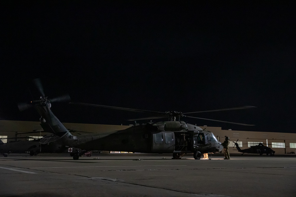 U.S. Army Door Gunner inspects rotor blades