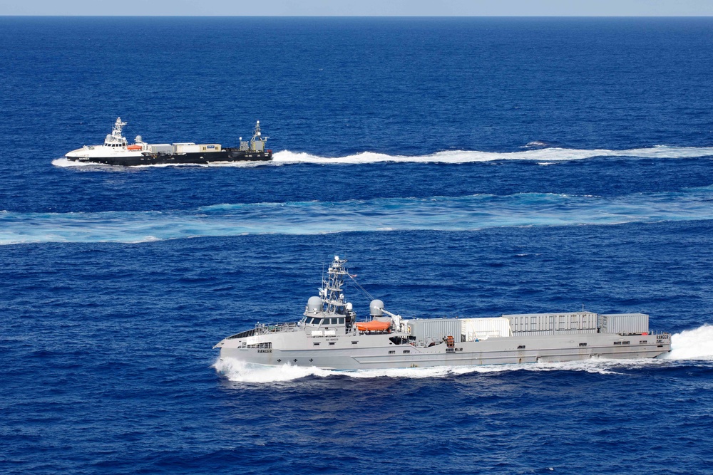 Unmanned Surface Vessels Steam Alongside USS Gabrielle Giffords