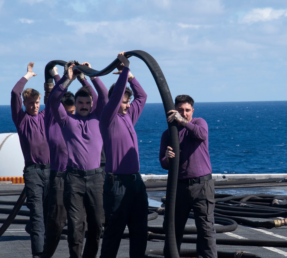 Sailors Drain A Hose