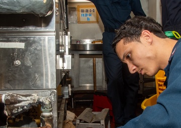 USS Ronald Reagan (CVN 76) Sailors install dishwasher