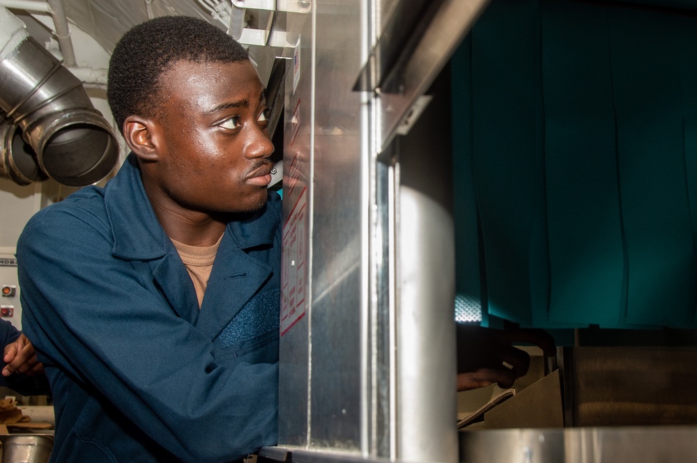 USS Ronald Reagan (CVN 76) Sailors install dishwasher
