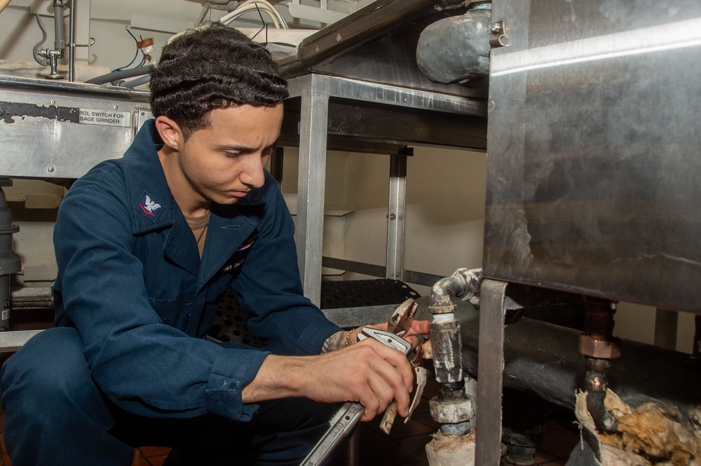 USS Ronald Reagan (CVN 76) Sailors install dishwasher