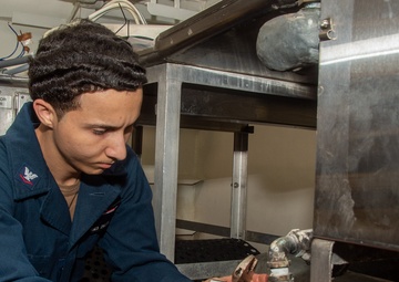 USS Ronald Reagan (CVN 76) Sailors install dishwasher