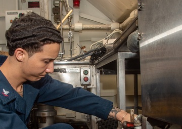 USS Ronald Reagan (CVN 76) Sailors install dishwasher