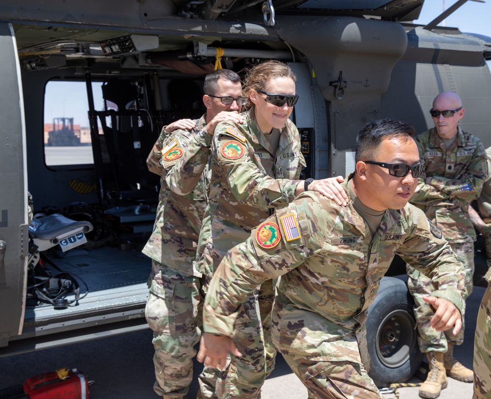 U.S. resuscitative and surgical team learns patient transport in a Blackhawk