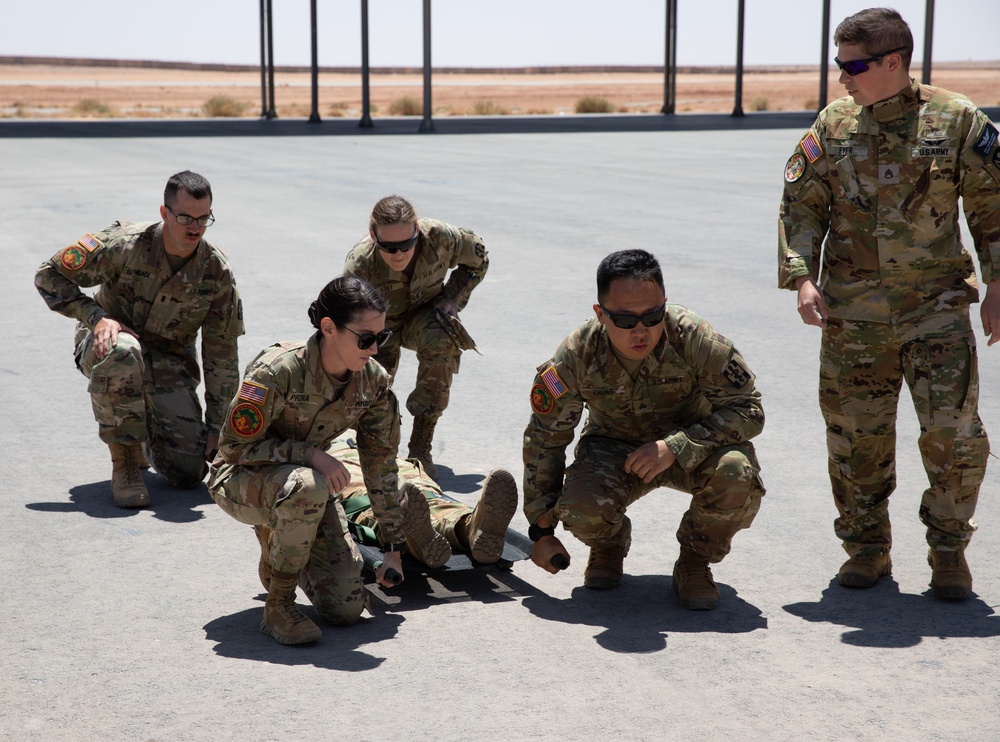 U.S. resuscitative and surgical team learns patient transport in a Blackhawk