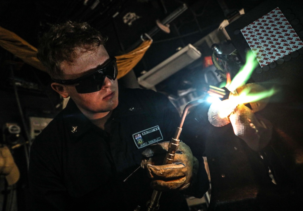 USS Dewey (DDG 105) Sailors Conduct Routine Operations in the Ship's General Workshop