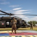 U.S. Army Door Gunner stands by with UH-60M Black Hawk