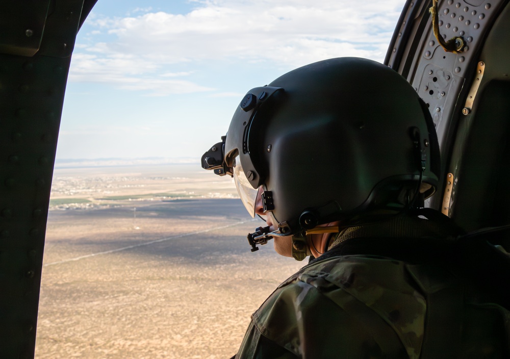 U.S. Army Door Gunner overlooks the desert