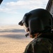 U.S. Army Door Gunner overlooks the desert