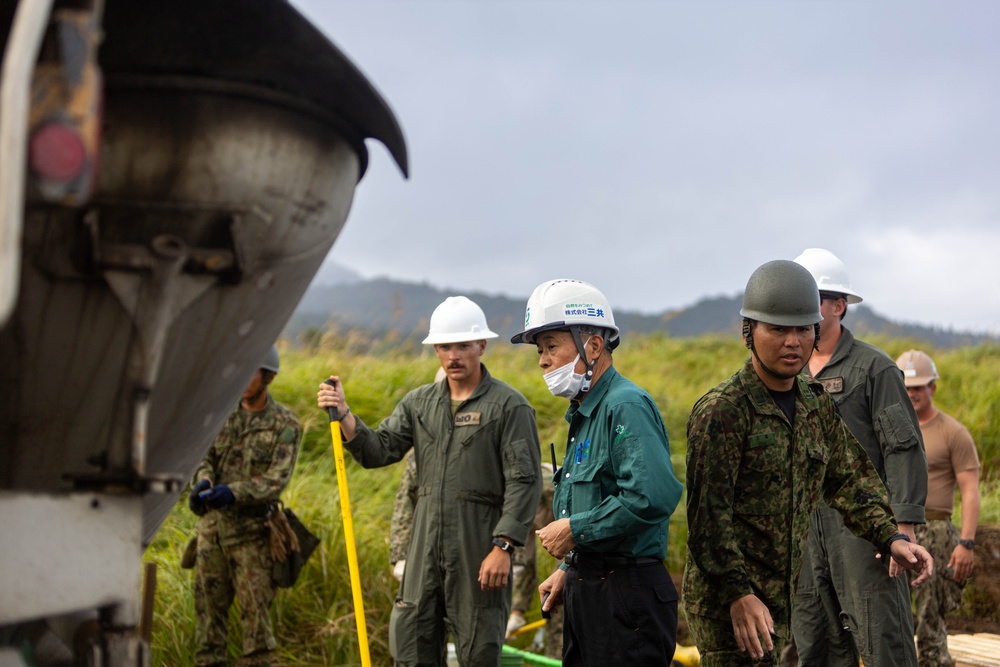 Cemented in Time - Japan Ground Self-Defense Force, U.S. Marines, and Sailors prepare Kirishima Training Area for airfield damage repair training