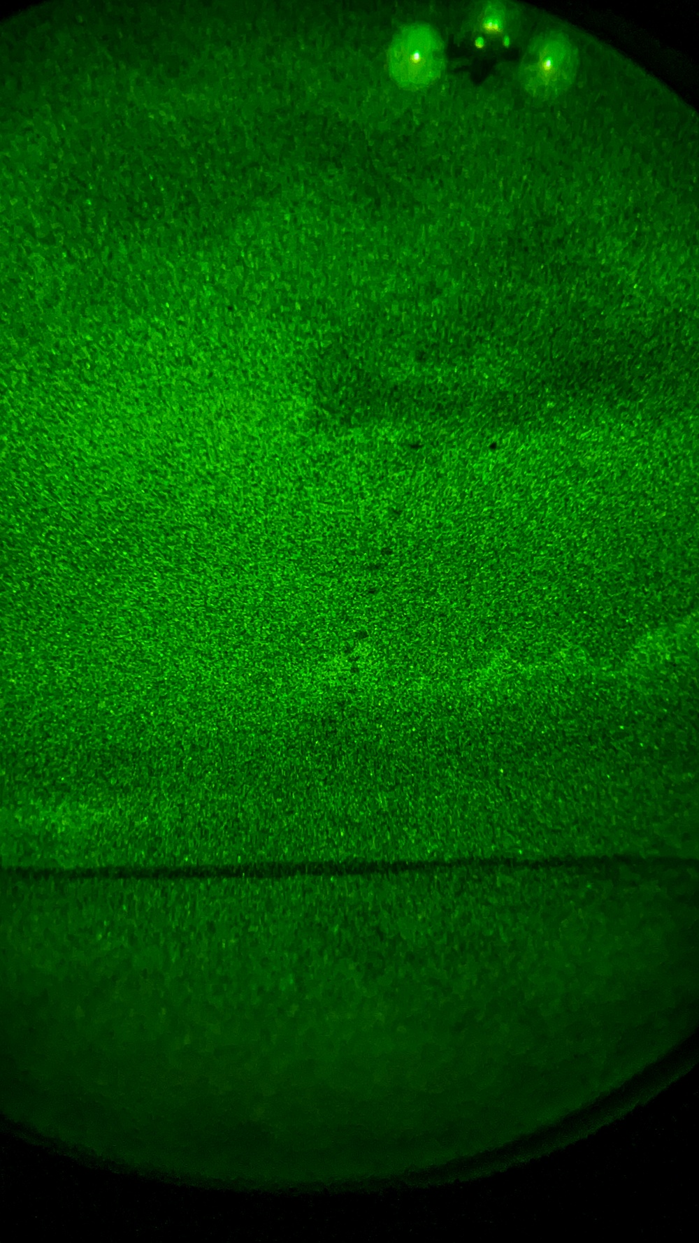 As seen through a night-vision device, U.S. paratroopers conduct a night  airborne operation from a