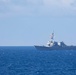 USS Rafael Peralta steams past the USS Ralph Johnson in the South China Sea.