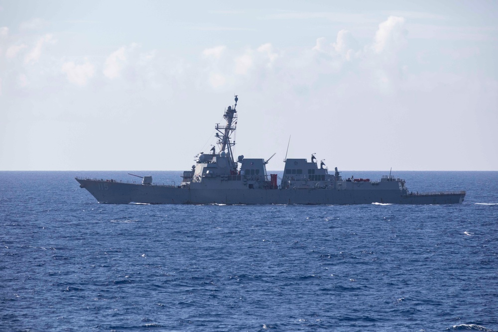 USS Rafael Peralta steams past the USS Ralph Johnson in the South China Sea.