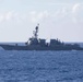 USS Rafael Peralta steams past the USS Ralph Johnson in the South China Sea.