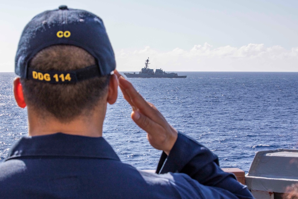 USS Rafael Peralta steams past the USS Ralph Johnson in the South China Sea.