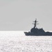 USS Rafael Peralta steams past the USS Ralph Johnson in the South China Sea.