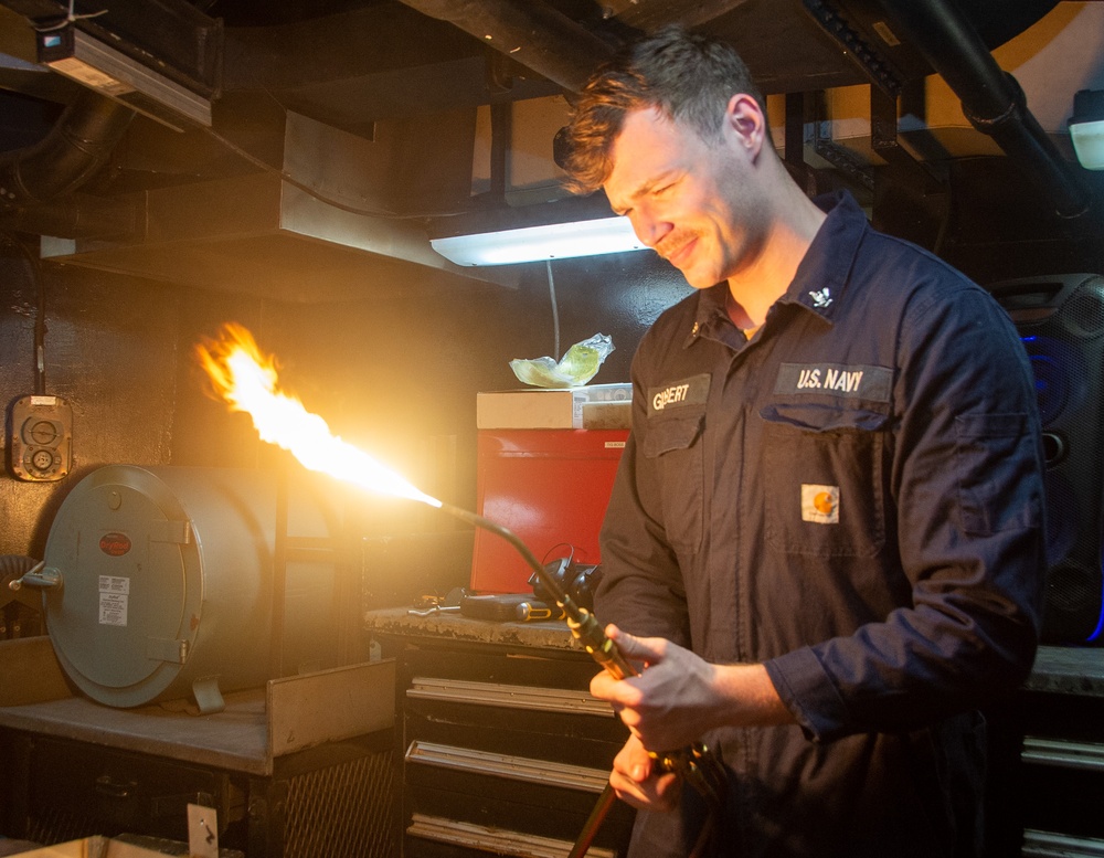 USS Ronald Reagan (CVN 76) Sailor braises piping