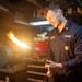 USS Ronald Reagan (CVN 76) Sailor braises piping