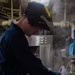 USS Ronald Reagan (CVN 76) Sailor braises piping
