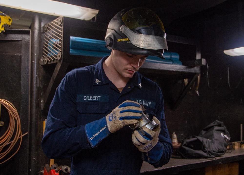 USS Ronald Reagan (CVN 76) Sailor braises piping