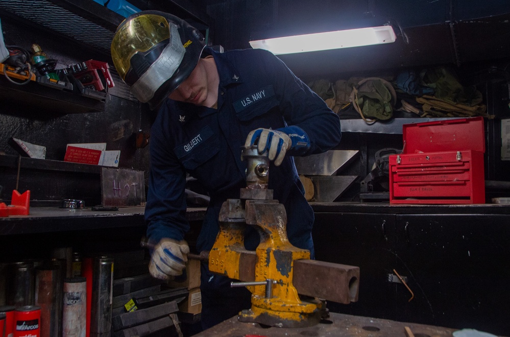 USS Ronald Reagan (CVN 76) Sailor braises piping