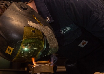 USS Ronald Reagan (CVN 76) Sailor braises piping