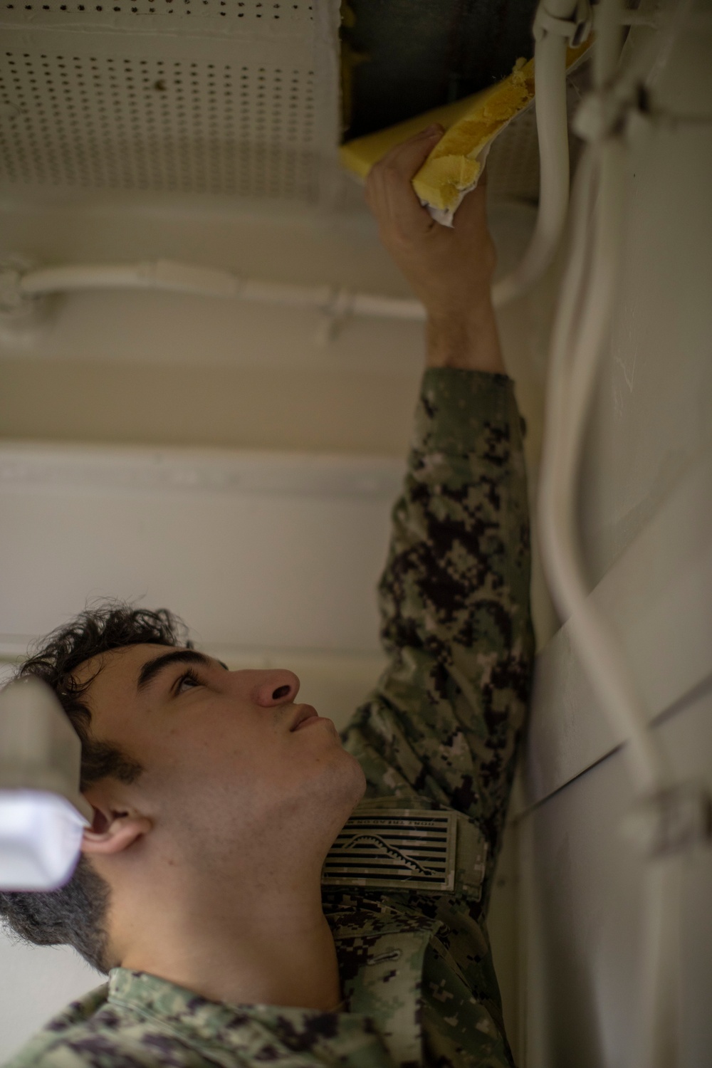 USS Tripoli Sailors Perform Maintenance