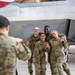 U.S. Air Force Airmen pose in front of an F-22 Raptor during Air Force Bash at Hangar 3 at Joint Base Elmendorf-Richardson, Alaska, Sept. 22, 2023.