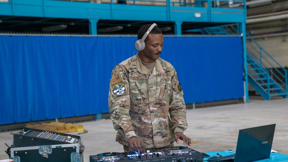 U.S. Air Force Staff Sgt. Stephon Wright, First Term Airman Course/Professional Development noncommissioned officer in charge and a ground transportation support supervisor, plays music for the Air Force Bash at Hangar 3