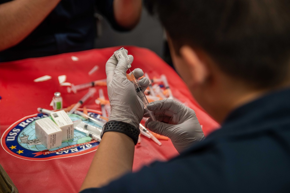 USS Ronald Reagan (CVN 76) Sailors administer flu shots