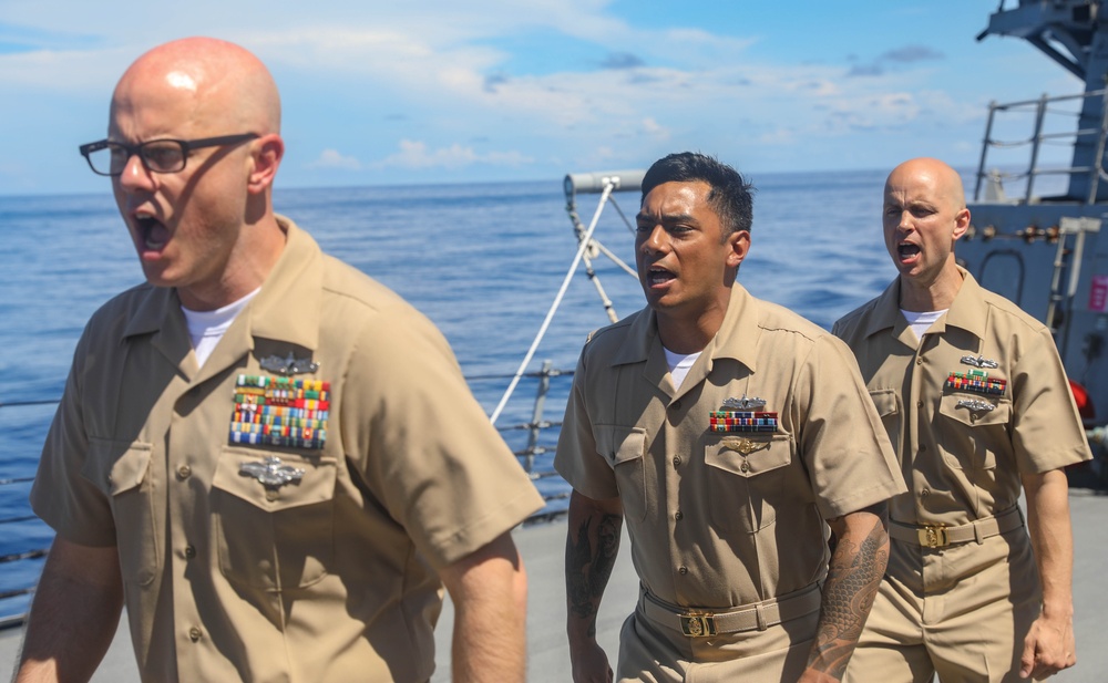 The Arleigh Burke-class guided-missile destroyer USS Rafael Peralta (DDG 115) hosts a chief pinning ceremony on the foc’sle in the South China Sea