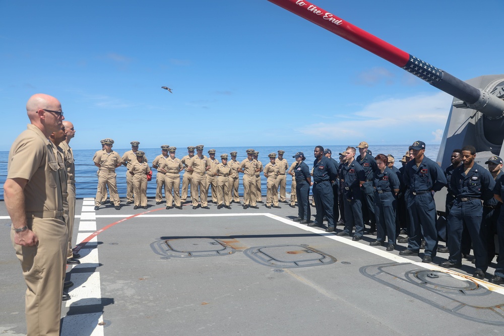 The Arleigh Burke-class guided-missile destroyer USS Rafael Peralta (DDG 115) hosts a chief pinning ceremony on the foc’sle in the South China Sea