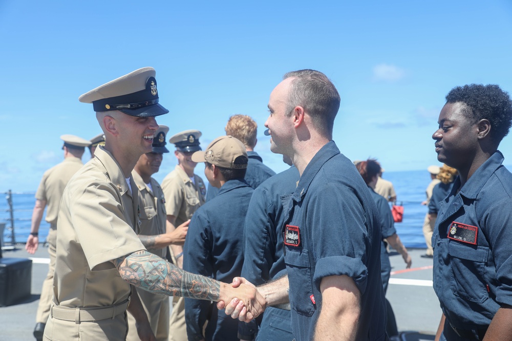 The Arleigh Burke-class guided-missile destroyer USS Rafael Peralta (DDG 115) hosts a chief pinning ceremony on the foc’sle in the South China Sea