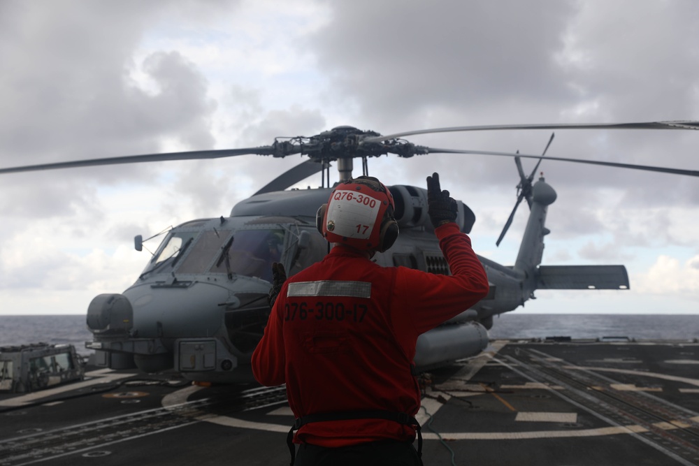 Sailors aboard the Arleigh Burke-class guided-missile destroyer USS Rafael Peralta (DDG 115) conduct a replenishment at sea with the Lewis and Clark-class dry cargo USNS Wally Schirra (T-AKE-8) in the South China Sea