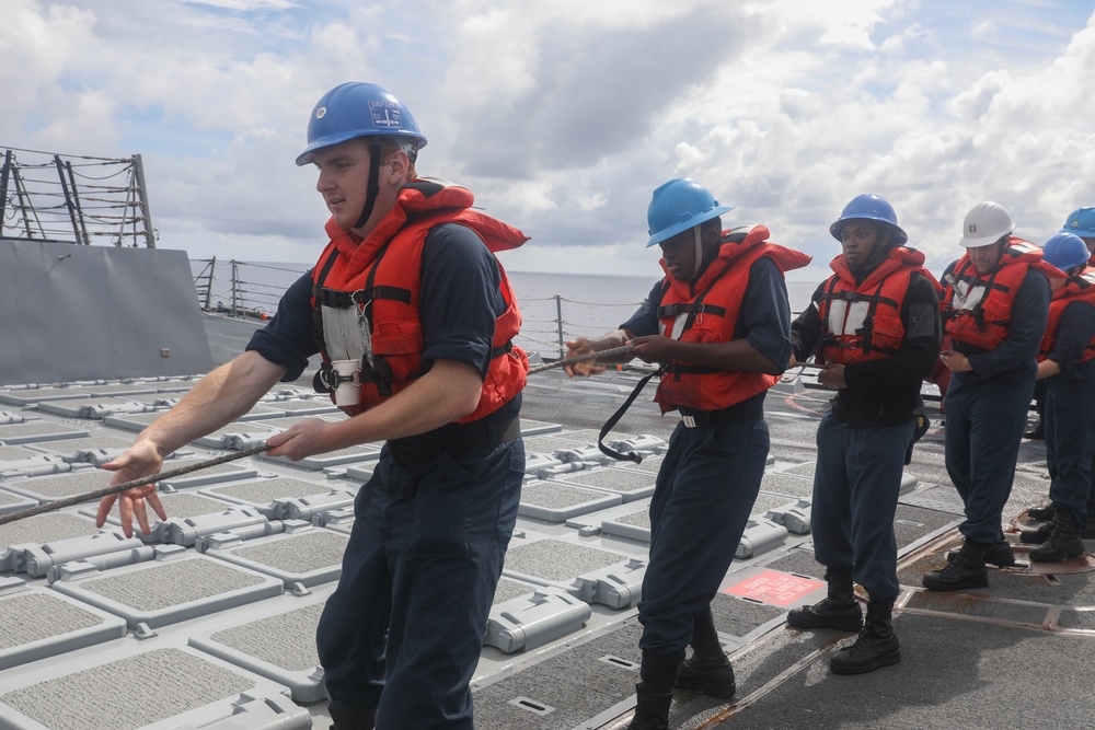 Sailors aboard the Arleigh Burke-class guided-missile destroyer USS Rafael Peralta (DDG 115) conduct a replenishment at sea with the Lewis and Clark-class dry cargo USNS Wally Schirra (T-AKE-8) in the South China Sea