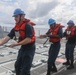 Sailors aboard the Arleigh Burke-class guided-missile destroyer USS Rafael Peralta (DDG 115) conduct a replenishment at sea with the Lewis and Clark-class dry cargo USNS Wally Schirra (T-AKE-8) in the South China Sea