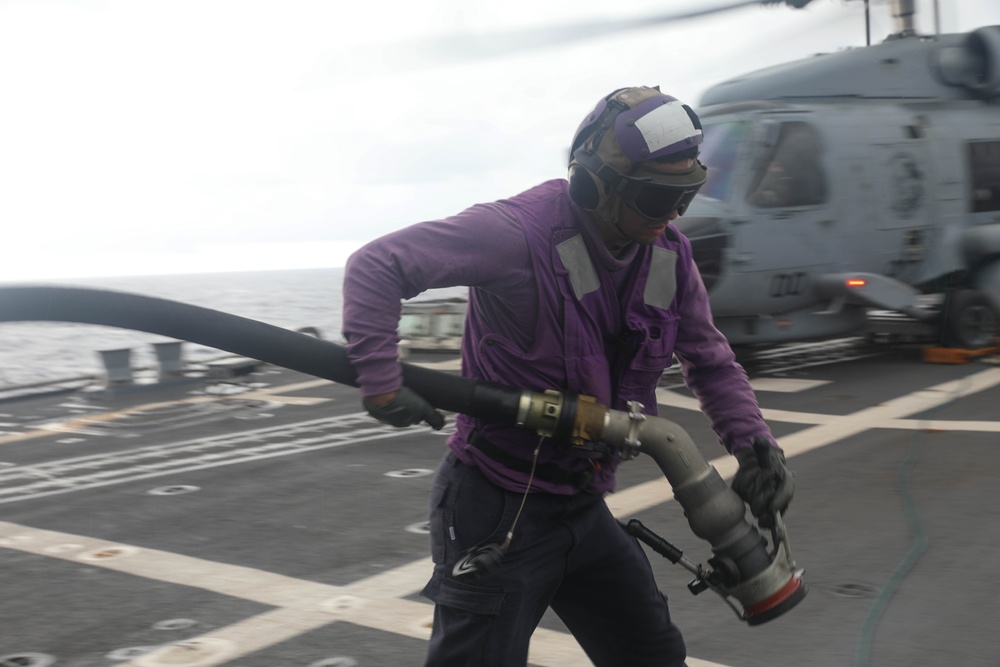 Sailors aboard the Arleigh Burke-class guided-missile destroyer USS Rafael Peralta (DDG 115) conduct a replenishment at sea with the Lewis and Clark-class dry cargo USNS Wally Schirra (T-AKE-8) in the South China Sea