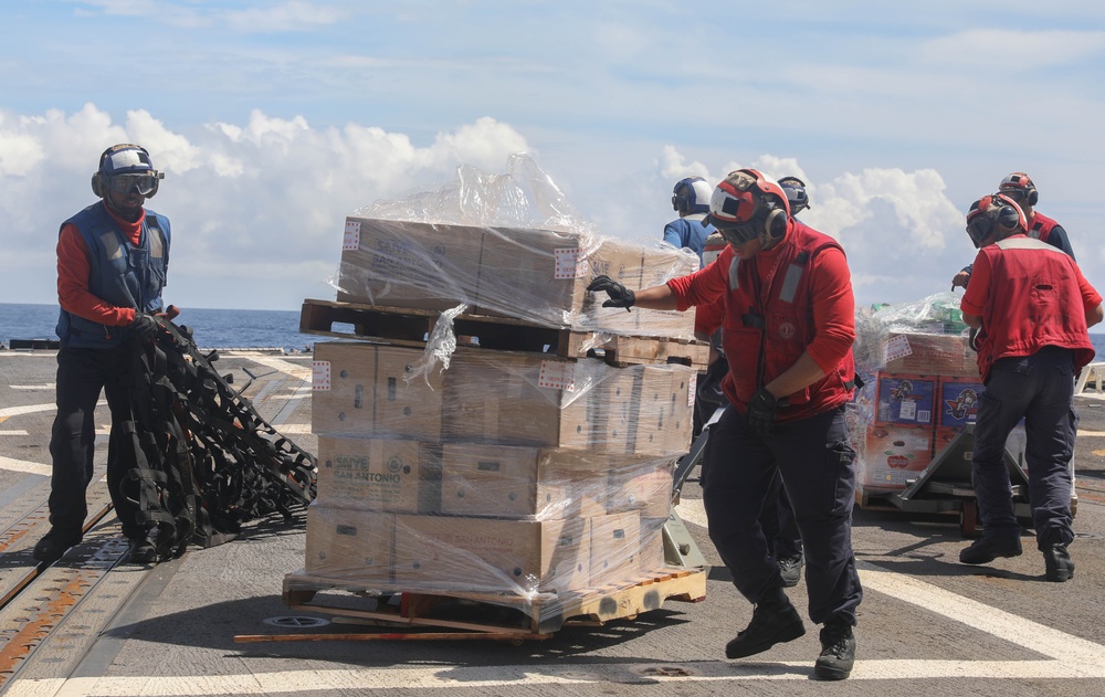 Sailors aboard the Arleigh Burke-class guided-missile destroyer USS Rafael Peralta (DDG 115) conduct a replenishment at sea with the Lewis and Clark-class dry cargo USNS Wally Schirra (T-AKE-8) in the South China Sea