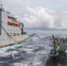 Sailors aboard the Arleigh Burke-class guided-missile destroyer USS Rafael Peralta (DDG 115) conduct a replenishment at sea with the Lewis and Clark-class dry cargo USNS Wally Schirra (T-AKE-8) in the South China Sea