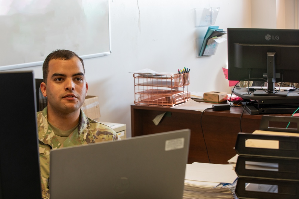 Spc. Luis Marrupe Working in His Office
