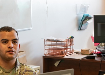 Spc. Luis Marrupe Working in His Office