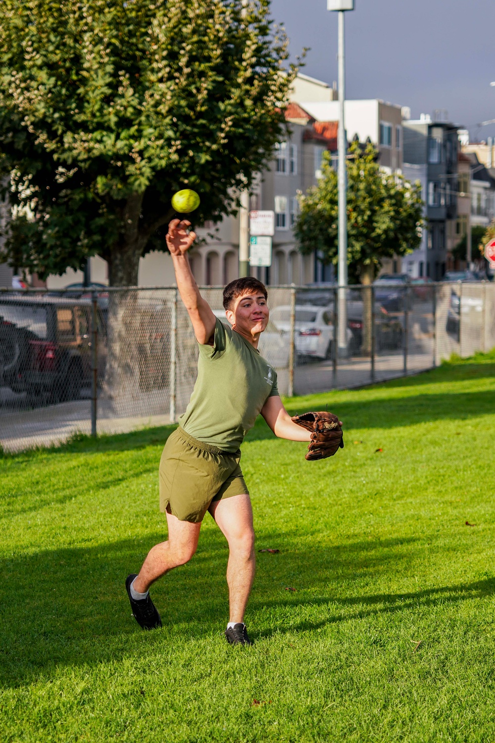 Service Members Play in a Softball Tournament