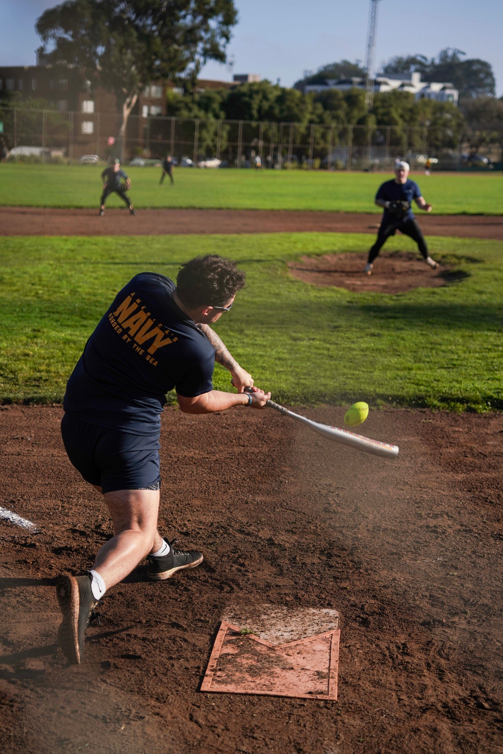 Service Members Play in a Softball Tournament