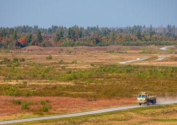 A Medium Tactical Vehicle Drives Across a Gunnery Range